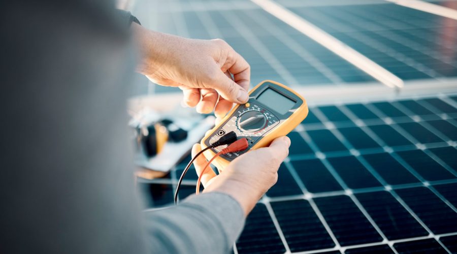 solar-panels-multimeter-and-engineering-hands-scaled